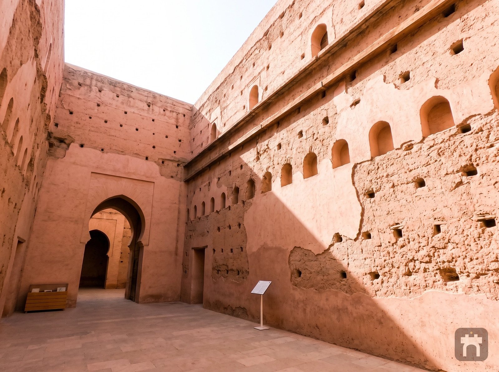 Restoration patches visible on the palace's ancient pisé walls